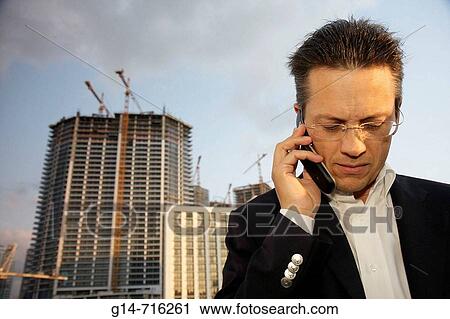 Stock Image - Florida, Miami, Bank of America Tower, Sky Terrace, high rise construction, condominium, building, Hispanic, man, mobile cell phone, listen,. Fotosearch