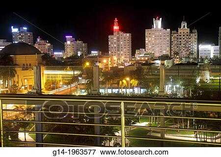 Stock Photo - Florida, Miami Beach, 17th Street, New World Center, New World Symphony, America Orchestral Academy, Frank Gehry, architect, upper terrace, view, Collins Avenue, hotels, night,.. Fotosearch