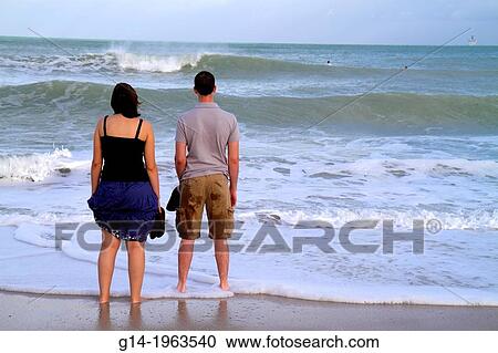 Florida, Miami Beach, Atlantic Ocean, beach, shore, surf, waves, water, woman, man, couple, standing, looking at, staring,. View Large Photo Image Stock Image - Florida, Miami Beach, Atlantic Ocean, beach, shore, surf, waves, water, woman, man, couple, standing, looking at, staring,.. Fotosearch