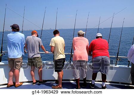 Stock Photo - Florida, Miami Beach, Atlantic Ocean, water, charter fishing boat, onboard, Black, man, waiting, rods, deep sea, standing room only,.. Fotosearch