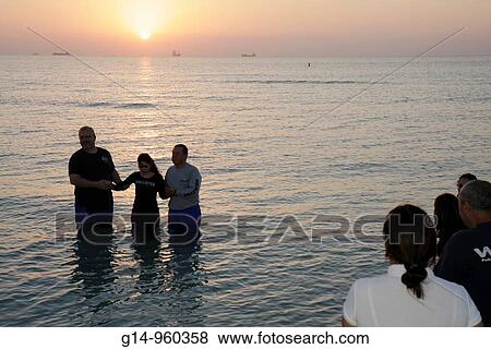 Florida, Miami Beach, Atlantic Ocean, shore, surf, sunrise, Easter Sunday, The Rock Church, independent, autonomous, nondenominational, Christian, members, religion, baptism, Hispanic, man, woman, group, dip in water, ritual, tradition, View Large Photo Image Stock Photo - Florida, Miami Beach, Atlantic Ocean, shore, surf, sunrise, Easter Sunday, The Rock Church, independent, autonomous, nondenominational, Christian, members, religion, baptism, Hispanic, man, woman, group, dip in water, ritual, tradition,. Fotosearch