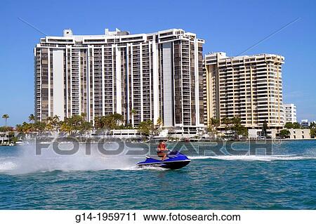 Florida, Miami Beach, Biscayne Bay, high rise, condominium, buildings, waterfront, jet ski, wave runner, woman, teen, girl,. View Large Photo Image Stock Image - Florida, Miami Beach, Biscayne Bay, high rise, condominium, buildings, waterfront, jet ski, wave runner, woman, teen, girl,.. Fotosearch
