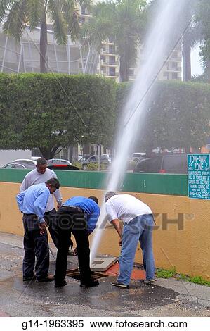 Florida, Miami Beach, city water main, pipe, break, broken, loss of pressure, leak, spewing, employees, man, Black, Hispanic, workers, looking, inspecting,. View Large Photo Image Stock Photography - Florida, Miami Beach, city water main, pipe, break, broken, loss of pressure, leak, spewing, employees, man, Black, Hispanic, workers, looking, inspecting,.. Fotosearch