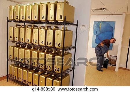 Stock Photograph - Florida, Miami Beach, Collins Avenue, Art Basel, The Artists Fair, The Shelborne Hotel, Greta Pemberton, artist, installation, metal shelf, plastic containers, gold color, numbered, man, bending, gallery, for sale,. Fotosearch