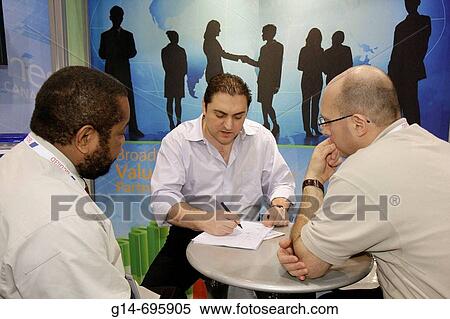 Stock Photography - Florida, Miami Beach, Convention Center, Internet Telephony Conference and Expo, telephone, technology, exhibitors, booths, buyer, seller, negotiate, Black, man,. Fotosearch