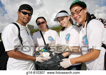 Florida, Miami Beach, Lummus Park, International Coastal Cleanup, volunteers, student, students, Hispanic, boy, girls, teenagers, teens, environment, team, pollution prevention, collect trash, gloves, protect ecosystem, pick up litter, View Large Photo Image Stock Photo - Florida, Miami Beach, Lummus Park, International Coastal Cleanup, volunteers, student, students, Hispanic, boy, girls, teenagers, teens, environment, team, pollution prevention, collect trash, gloves, protect ecosystem, pick up litter,. Fotosearch