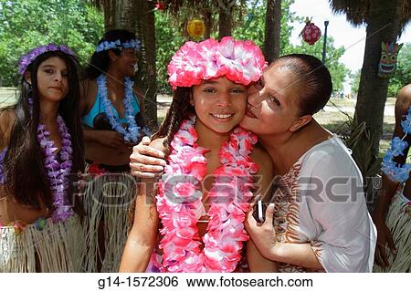Stock Photograph - Florida, Miami Beach, North Beach, North Shore Park, luau party, Hispanic, teen, girl, friends, leis, posing for picture, mother, woman, hugging, family,. Fotosearch