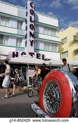 Florida, Miami Beach,? Ocean Drive?, Art Deco Weekend, historic district, architecture, street festival, event, celebration, classic car exhibit, spare tire, spoke wheel, man, men, woman, walking, bicycle, Colony Hotel, View Large Photo Image Stock Photo - Florida, Miami Beach,? Ocean Drive?, Art Deco Weekend, historic district, architecture, street festival, event, celebration, classic car exhibit, spare tire, spoke wheel, man, men, woman, walking, bicycle, Colony Hotel,. Fotosearch