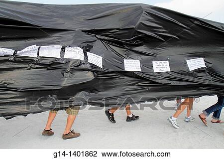 Stock Image - Florida, Miami Beach, oil spill protest, offshore drilling, black plastic sheet represents slick,. Fotosearch