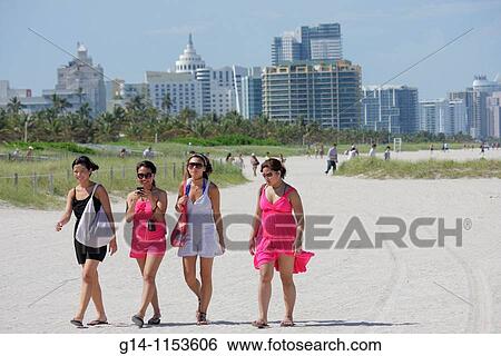 Florida, Miami Beach, public beach, ocean front, Asian, woman, young adult, group, beachcomber, walking, girlfriends, skyline, dunes, sand, Spring Break, View Large Photo Image Stock Photograph - Florida, Miami Beach, public beach, ocean front, Asian, woman, young adult, group, beachcomber, walking, girlfriends, skyline, dunes, sand, Spring Break,. Fotosearch