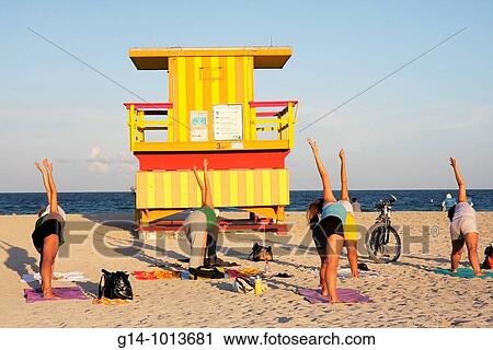 Florida, Miami Beach, sand, shore, beach, lifeguard stand, station, yoga class, woman, women, exercise, health, fitness, pose, asana, triangle pose, View Large Photo Image Stock Image - Florida, Miami Beach, sand, shore, beach, lifeguard stand, station, yoga class, woman, women, exercise, health, fitness, pose, asana, triangle pose,. Fotosearch