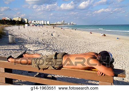 Florida, Miami Beach, South Pointe Park, Atlantic Ocean, man, sunbathing, tanning, lying down, sand, public beach, surf,. View Large Photo Image Stock Image - Florida, Miami Beach, South Pointe Park, Atlantic Ocean, man, sunbathing, tanning, lying down, sand, public beach, surf,.. Fotosearch