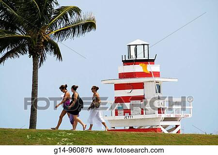 Florida, Miami Beach, South Pointe Park, Atlantic Ocean, Government Cut, urban public space, seashore, dunes, palm tree, woman, women, walking, lifeguard stand, lighthouse design, View Large Photo Image Stock Photograph - Florida, Miami Beach, South Pointe Park, Atlantic Ocean, Government Cut, urban public space, seashore, dunes, palm tree, woman, women, walking, lifeguard stand, lighthouse design,. Fotosearch