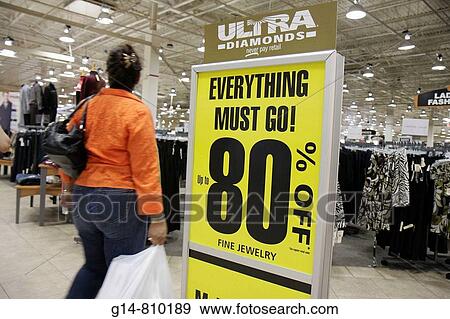 Stock Photo - Florida, Miami, Dolphin Mall, Burlington Coat Factory, discount, outlet, Hispanic woman, walks past sign, sale, 80 off,? everything must go?, shopping,. Fotosearch