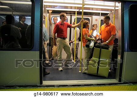 Florida, Miami, Government Center, Metromover, mass transit, free public transportation, automated people mover, station, stop, car, door, open, Hispanic, man, woman, passenger, standing, boxes, looking out, holding pole, View Large Photo Image Stock Photo - Florida, Miami, Government Center, Metromover, mass transit, free public transportation, automated people mover, station, stop, car, door, open, Hispanic, man, woman, passenger, standing, boxes, looking out, holding pole,. Fotosearch