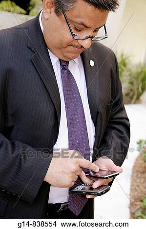 Picture - Florida, Miami, Little Haiti, Lafayette Apartments, affordable housing, rental building, subsidized, opening ceremony, Hispanic, man, businessman, blackberry, iphone,. Fotosearch
