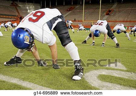 Florida, Miami, Orange Bowl, All-American Offense-Defense Bowl, high school football players, pregame warm-up, male, teen, student, uniform, equipment, helmet, sport, stretch, team, View Large Photo Image Stock Photo - Florida, Miami, Orange Bowl, All-American Offense-Defense Bowl, high school football players, pregame warm-up, male, teen, student, uniform, equipment, helmet, sport, stretch, team,. Fotosearch
