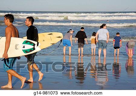 Florida, New Smyrna Beach, Flagler Avenue Beach, Atlantic Ocean, public beach, seashore, waves, woman, man, boy, girl, teen, family,, wade, wading, reflection, surfboard, surfer surf, View Large Photo Image Stock Image - Florida, New Smyrna Beach, Flagler Avenue Beach, Atlantic Ocean, public beach, seashore, waves, woman, man, boy, girl, teen, family,, wade, wading, reflection, surfboard, surfer surf,. Fotosearch