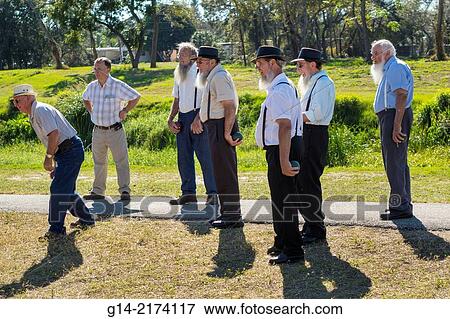 Stock Photo - Florida, Sarasota, Pine Craft, Amish, Mennonite, community, winter retreat, traditional, conservative, clothing, religious, Pinecraft Park, man, friends, playing, bocce ball, game, traditional clothing, suspenders,.. Fotosearch