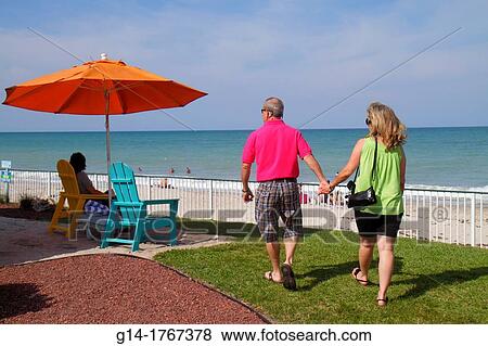 Florida, Vero Beach, Atlantic Ocean, shore, man, woman, couple, holding hands walking, View Large Photo Image Stock Photo - Florida, Vero Beach, Atlantic Ocean, shore, man, woman, couple, holding hands walking,. Fotosearch