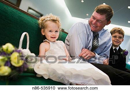 Flower girl and father in church View Large Photo Image Stock Image - Flower girl and father in church. Fotosearch