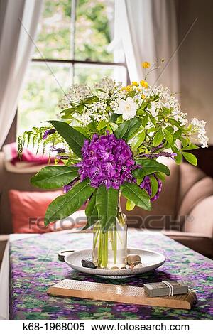 Flowers in a vase in a living room on Saturna Island, Gulf Islands, British Columbia, Canada View Large Photo Image Stock Photography - Flowers in a vase in a living room on Saturna Island, Gulf Islands, British Columbia, Canada. Fotosearch