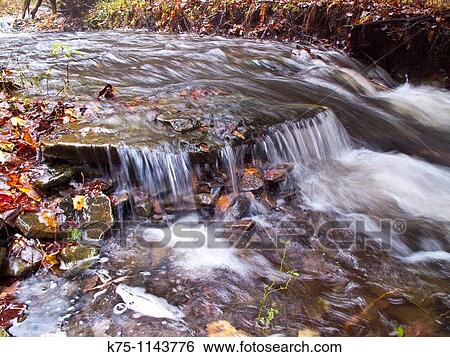 Flowing creek in autumn View Large Photo Image Stock Photograph - Flowing creek in autumn. Fotosearch