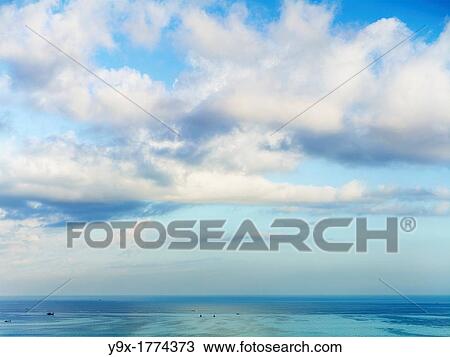 Fluffy clouds over the ocean in Bali, Indonesia View Large Photo Image Stock Image - Fluffy clouds over the ocean in Bali, Indonesia. Fotosearch