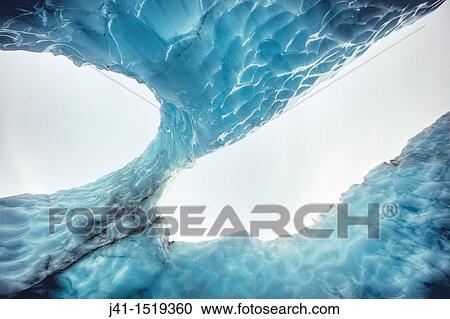 Stock Image - Fluted ice wall arch, looking up from inside a crevasse, Franz Josef Glacier, Westland National Park, West Coast, South Island, New Zealand. Fotosearch