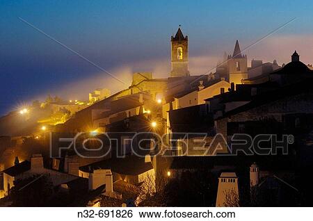 Fog in Monsaraz, fortified town fron alto Alentejo at Dawn. Portugal View Large Photo Image Stock Photograph - Fog in Monsaraz, fortified town fron alto Alentejo at Dawn. Portugal. Fotosearch