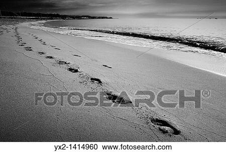 Stock Image - Footprints in the sand on the beach, Mataro, Catalonia, Spain. Fotosearch