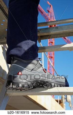 Stock Photography - Footwear for professional use, Protective boots, construction worker, Scaffold, Donostia, San Sebastian, Gipuzkoa, Basque Country, Spain. Fotosearch