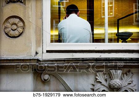 Stock Photo - forefront of executive working inside an office. Fotosearch