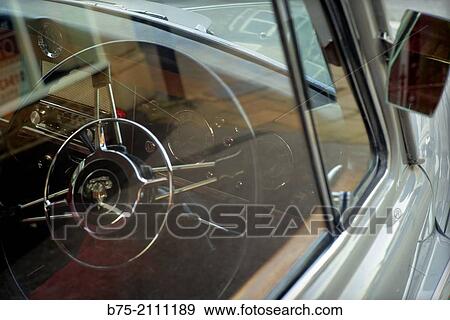 Foreground inside an antique car brand Rover With the wheel in England, UK, Europe. View Large Photo Image Stock Photo - Foreground inside an antique car brand Rover With the wheel in England, UK, Europe.. Fotosearch