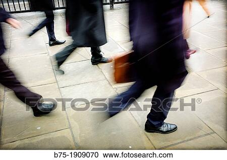 foreground moving executives walking around town View Large Photo Image Stock Image - foreground moving executives walking around town. Fotosearch