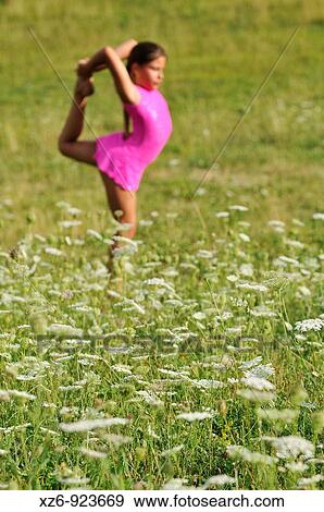 foreground of white flowers with a girl doing gymnastics at the bottom View Large Photo Image Stock Photo - foreground of white flowers with a girl doing gymnastics at the bottom. Fotosearch