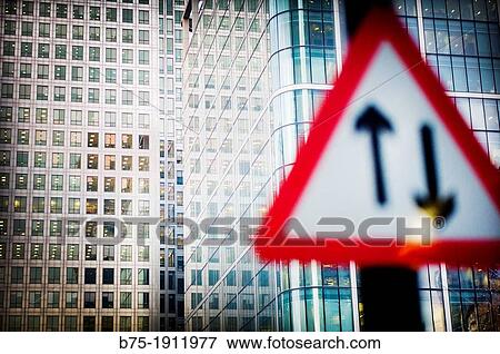 foreground traffic signal two directions with modern office building in the background, Canary Wharf, London, England, UK View Large Photo Image Stock Photo - foreground traffic signal two directions with modern office building in the background, Canary Wharf, London, England, UK. Fotosearch