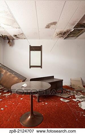 Stock Photo - Forgotten furniture and water damage with retro carpeting in a guest room of an abandoned motel in Ontario, Canada.. Fotosearch