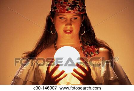 Fortune teller gazes into crystal ball View Large Photo Image Stock Photo - Fortune teller gazes into crystal ball. Fotosearch