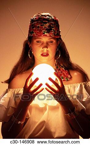 Fortune teller gazes into crystal ball View Large Photo Image Stock Photo - Fortune teller gazes into crystal ball. Fotosearch