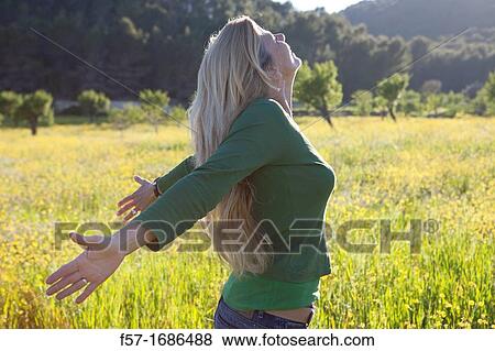 Forty something year old woman sun worshipping in a meadow View Large Photo Image Stock Photo - Forty something year old woman sun worshipping in a meadow. Fotosearch