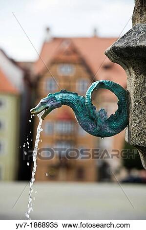 Stock Photography - Fountain with form of dragon, in the main square of Cheb, surrounded by Medieval houses Cheb, Bohemia, Czech Republic, Europe. Fotosearch