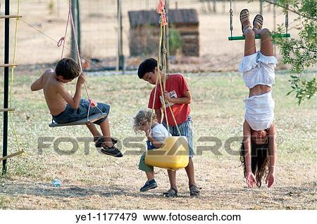 Four children playing on a swingset. View Large Photo Image Stock Photo - Four children playing on a swingset.. Fotosearch