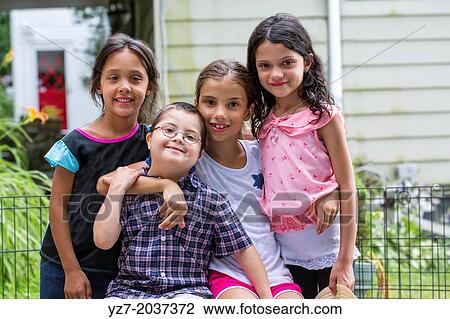 Four cousins ages 6-9 years old hugging and posing for camera. View Large Photo Image Stock Image - Four cousins ages 6-9 years old hugging and posing for camera.. Fotosearch