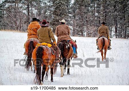 Four cowboys riding horses in the snow View Large Photo Image Stock Photography - Four cowboys riding horses in the snow. Fotosearch