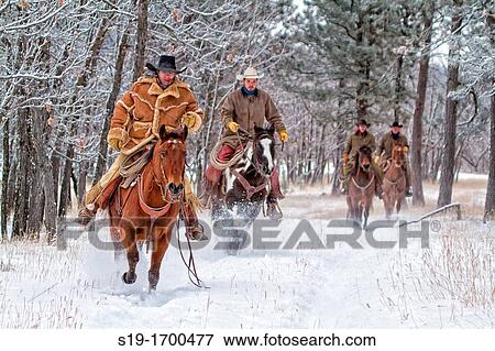 Four cowboys riding in the snow View Large Photo Image Stock Photo - Four cowboys riding in the snow. Fotosearch