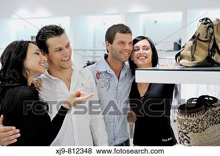Four friends looking in a bag shop. View Large Photo Image Stock Photo - Four friends looking in a bag shop.. Fotosearch
