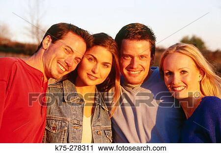 Stock Image - Four friends outdoors. Fotosearch