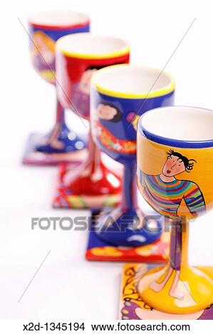 Four hand painted porcelain goblets on matching coasters featuring maidens Isolated View Large Photo Image Picture - Four hand painted porcelain goblets on matching coasters featuring maidens Isolated. Fotosearch