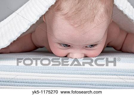Stock Image - Four Month old Baby under a Bed Sheet. Fotosearch